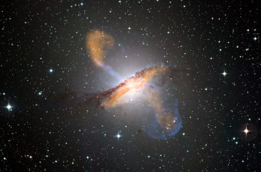 Active galaxy with jets emanating from a central black hole, set against a starry background.